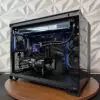 Front angled view of the DKBPC Core PC with tempered glass panels, RGB lighting, Thermalright liquid cooler, and MSI RTX 3060 Ti graphics card.