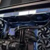 Close-up of the DKBPC Core PC highlighting the Thermalright liquid cooler, RGB fans, sleeved cables, and custom-built gaming hardware.