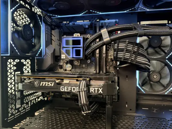 Close-up of the DKBPC Core PC featuring the MSI GeForce RTX 3060 Ti graphics card, Intel Core i7-9700K cooling system, and clean cable management.