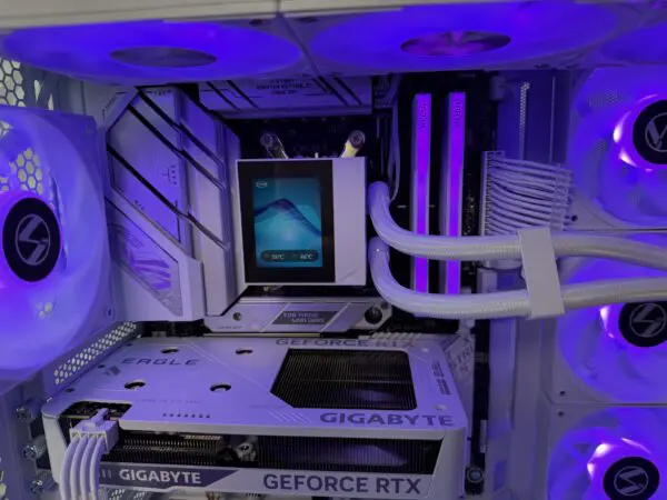 Close-up of the DKBPC Signature PC components featuring the Ryzen 7 7800X3D, RTX 5060, liquid cooling, and white sleeved cables